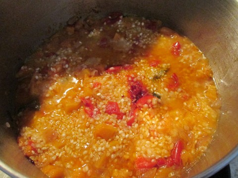 Versare il riso e aggiungere gradatamente il brodo vegetale e mescolare sempre a fiamma moderata